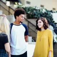 Picture of teenagers standing together and talking.